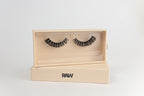 False eyelashes in an open wooden box with 'RAW' branding on a light gray background